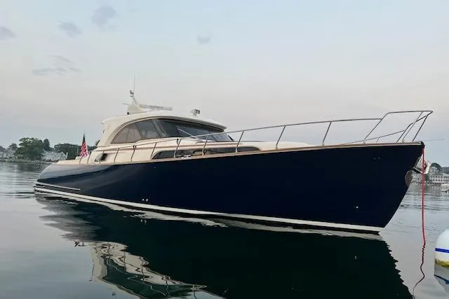 Mamma Mia Yacht Photos Pics 2006 Mochi Craft 51 Dolphin yacht on calm water, showcasing sleek design and elegance.