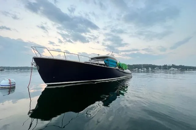 Mamma Mia Yacht Photos Pics 2006 Mochi Craft 51 Dolphin yacht on calm water at sunset.