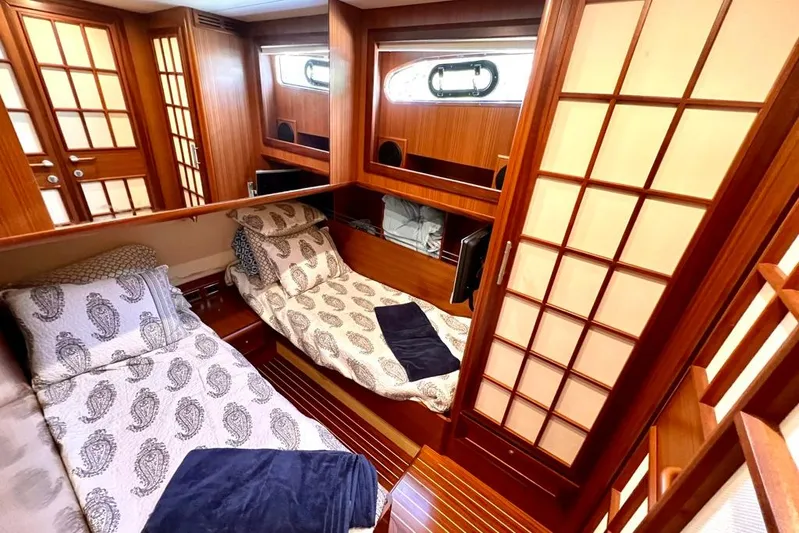 Mamma Mia Yacht Photos Pics Luxurious 2006 Mochi Craft 51 Dolphin yacht cabin with elegant wood paneling and twin beds.