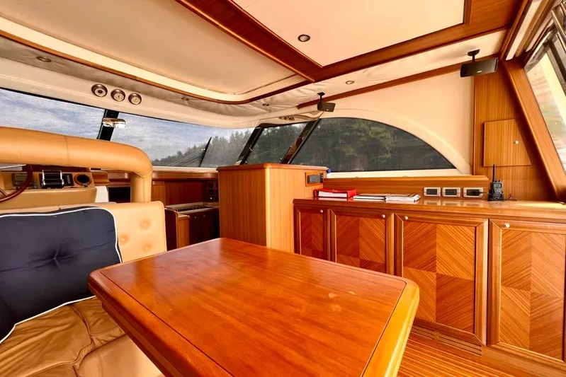 Mamma Mia Yacht Photos Pics Luxurious interior of 2006 Mochi Craft 51 Dolphin yacht with elegant wood finishes.
