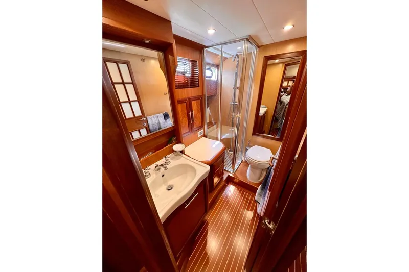 Mamma Mia Yacht Photos Pics Luxurious bathroom in 2006 Mochi Craft 51 Dolphin yacht with wood accents and modern fixtures.