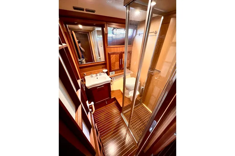 Mamma Mia Yacht Photos Pics Luxurious bathroom in 2006 Mochi Craft 51 Dolphin yacht with wood accents and glass shower.