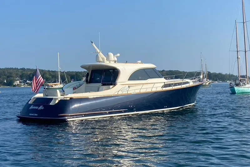 Mamma Mia Yacht Photos Pics 2006 Mochi Craft 51 Dolphin yacht on calm water, displaying an American flag.