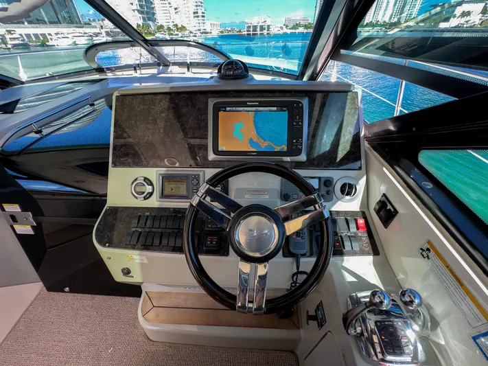 2013 Sea Ray 470 Sundancer @ Cancun Yacht Photos Pics Helm of 2013 Sea Ray 470 Sundancer with navigation display and steering wheel.