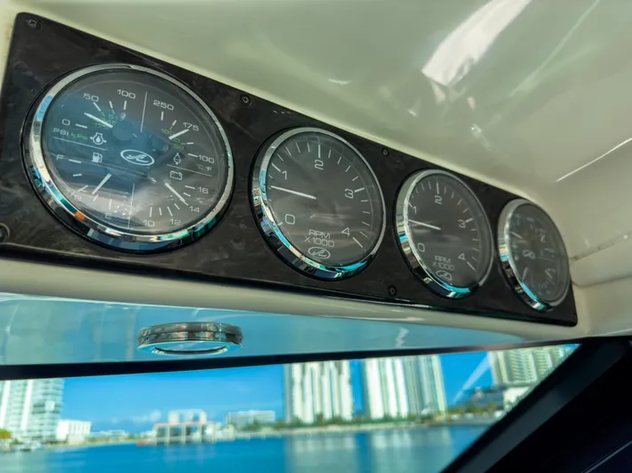 2013 Sea Ray 470 Sundancer @ Cancun Yacht Photos Pics Dashboard gauges on a 2013 Sea Ray 470 Sundancer yacht with cityscape view.