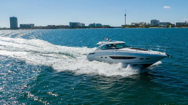 2013 Sea Ray 470 Sundancer @ Cancun Yacht Photos Pics 2013 Sea Ray 470 Sundancer cruising on blue ocean near city skyline.