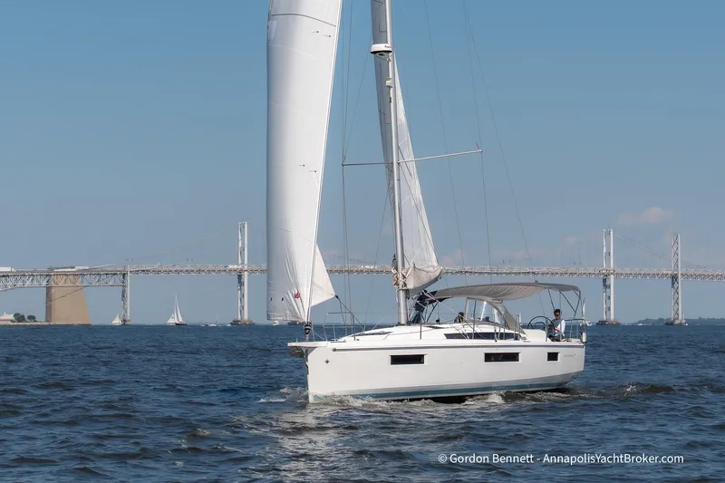 No Regrets Yacht Photos Pics 2019 Jeanneau Sun Odyssey 440 sailing near a bridge on a sunny day.