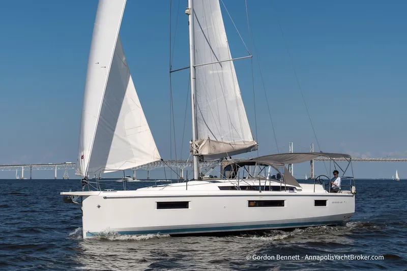No Regrets Yacht Photos Pics 2019 Jeanneau Sun Odyssey 440 sailing on open water with bridge in background.