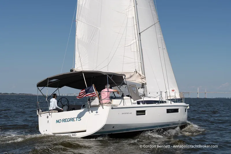 No Regrets Yacht Photos Pics 2019 Jeanneau Sun Odyssey 440 sailing with American flag on open water.