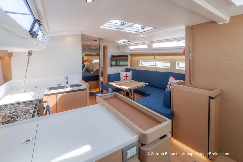 No Regrets Yacht Photos Pics Interior of 2019 Jeanneau Sun Odyssey 440 yacht, featuring modern kitchen and seating area.