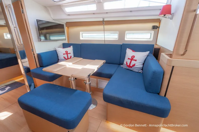 No Regrets Yacht Photos Pics Interior of 2019 Jeanneau Sun Odyssey 440 yacht with blue seating and nautical decor.