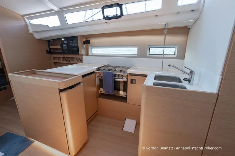 No Regrets Yacht Photos Pics Modern kitchen interior of 2019 Jeanneau Sun Odyssey 440 yacht, featuring sleek design and appliances.