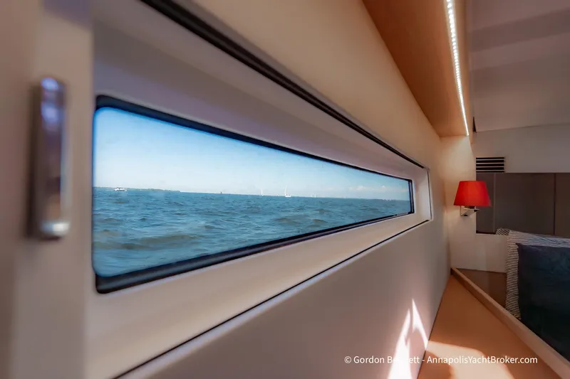 No Regrets Yacht Photos Pics Cabin view from 2019 Jeanneau Sun Odyssey 440, showcasing ocean through window.