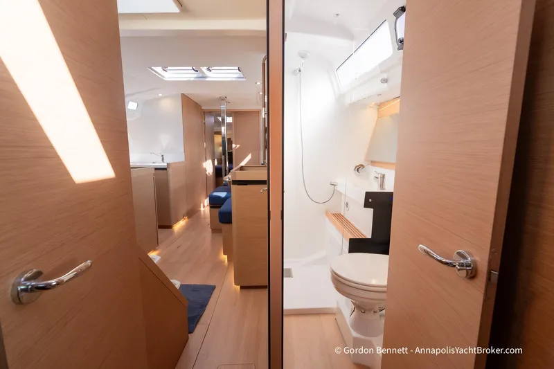 No Regrets Yacht Photos Pics Interior of 2019 Jeanneau Sun Odyssey 440 yacht, featuring modern bathroom and cozy living space.