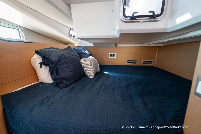 No Regrets Yacht Photos Pics Cozy cabin interior of 2019 Jeanneau Sun Odyssey 440 yacht with navy bedding.
