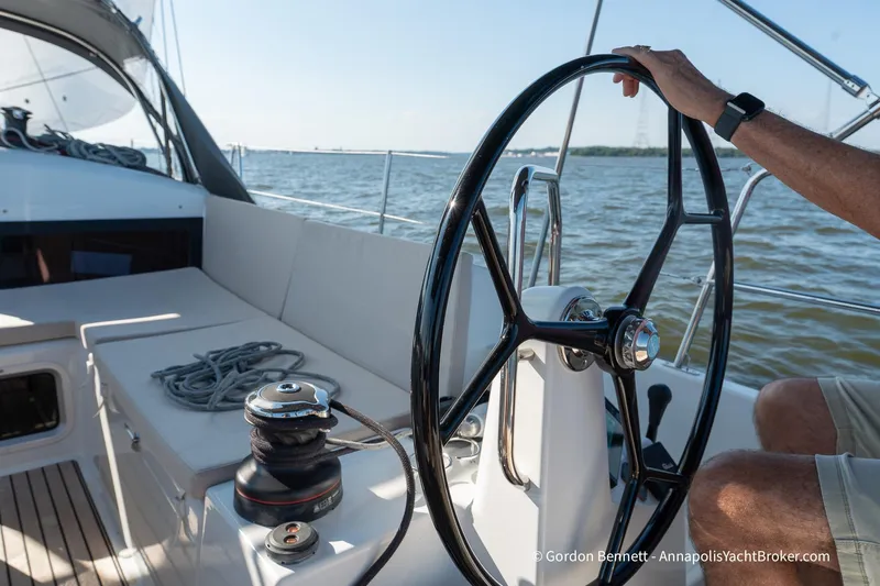 No Regrets Yacht Photos Pics 2019 Jeanneau Sun Odyssey 440 sailboat cockpit with steering wheel and winch on open water.