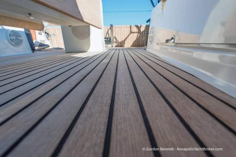 No Regrets Yacht Photos Pics Teak deck of 2019 Jeanneau Sun Odyssey 440 yacht, showcasing sleek design and craftsmanship.
