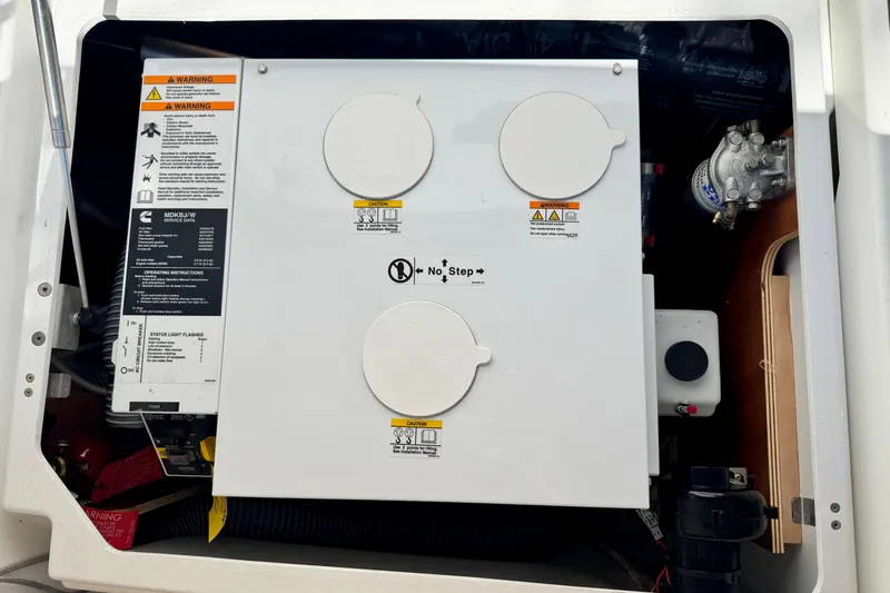 No Regrets Yacht Photos Pics Engine compartment of a 2019 Jeanneau Sun Odyssey 440 sailboat, featuring warning labels and components.