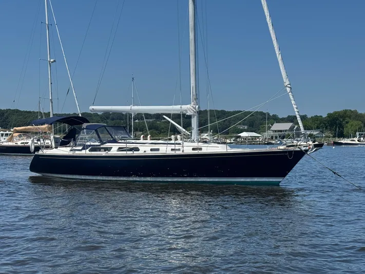 Basia Yacht Photos Pics 1987 Sabre 42 sailboat anchored on calm water under clear blue sky.