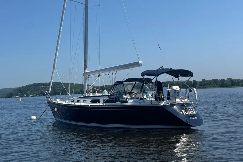 Basia Yacht Photos Pics 1987 Sabre 42 sailboat anchored on calm water with clear blue sky.