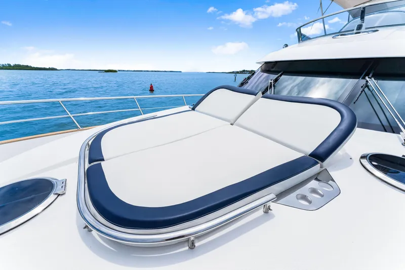 Madrine Yacht Photos Pics 2015 Riviera 54 Belize Daybridge yacht with sunbed on deck, ocean view.