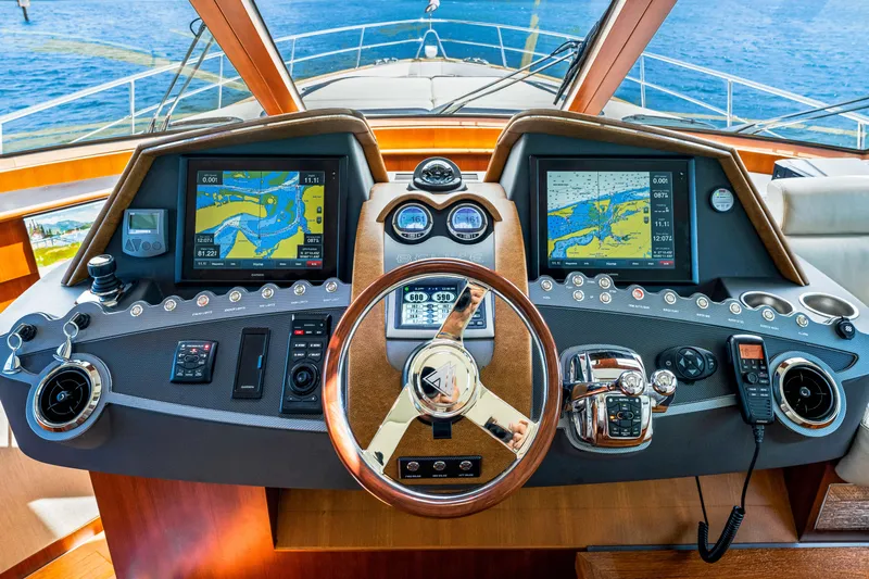 Madrine Yacht Photos Pics Cockpit of 2015 Riviera 54 Belize Daybridge yacht with navigation screens and controls.
