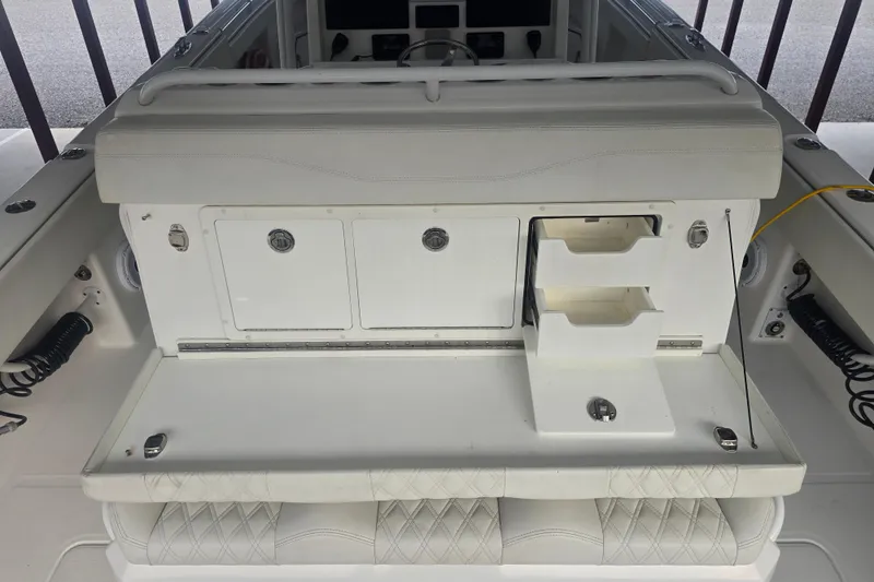 Humble Beginnings Yacht Photos Pics 2022 Invincible 33 Catamaran interior with storage compartments and seating.