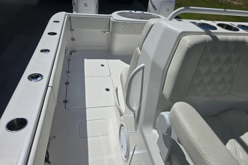 Humble Beginnings Yacht Photos Pics 2022 Invincible 33 Catamaran interior with cushioned seating and cup holders.