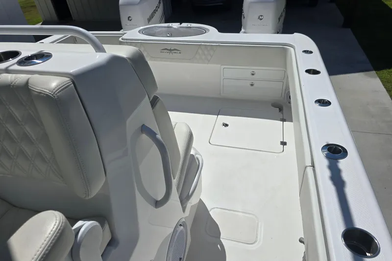 Humble Beginnings Yacht Photos Pics 2022 Invincible 33 Catamaran interior with white seating and storage compartments.