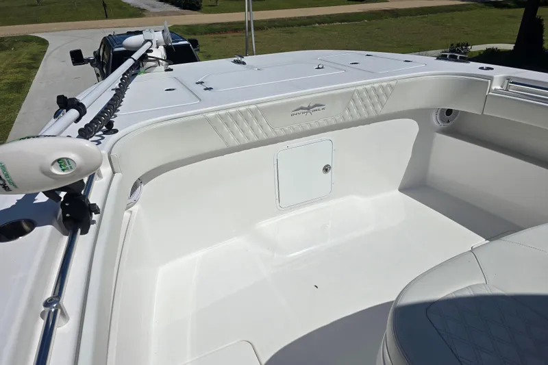 Humble Beginnings Yacht Photos Pics 2022 Invincible 33 Catamaran boat interior with white seating and storage compartment.