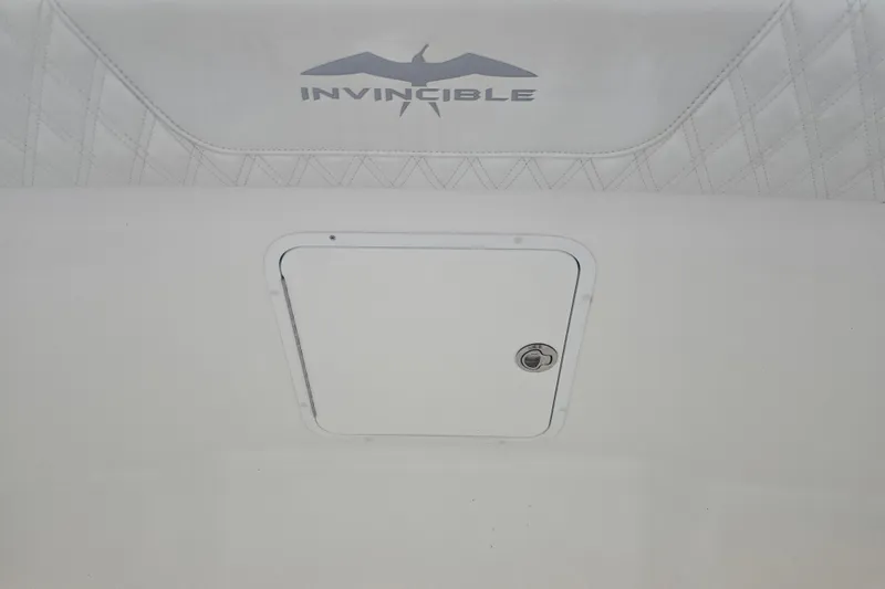 Humble Beginnings Yacht Photos Pics 2022 Invincible 33 Catamaran interior detail with logo and storage compartment.