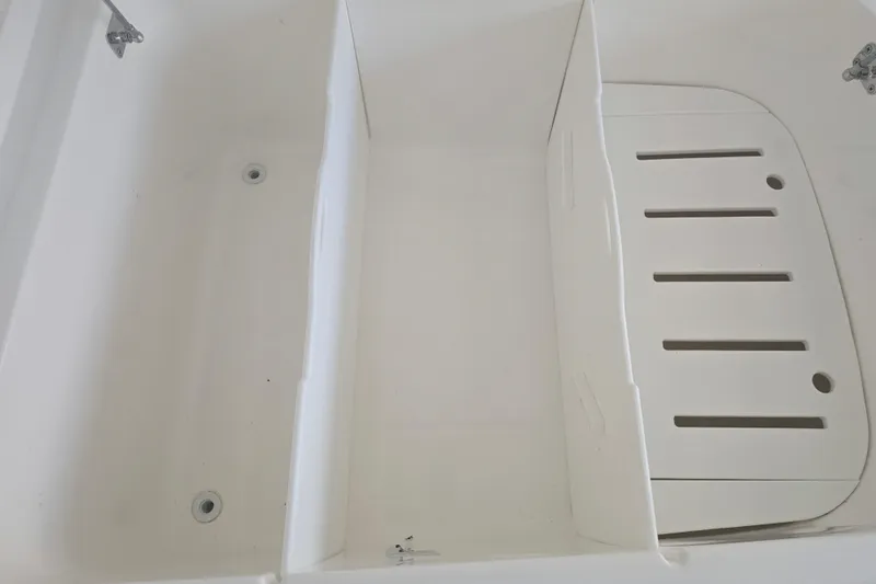 Humble Beginnings Yacht Photos Pics 2022 Invincible 33 Catamaran interior detail, featuring a white compartment with drainage holes.