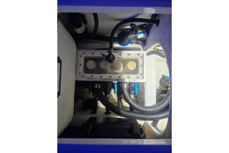 Humble Beginnings Yacht Photos Pics Engine compartment of 2022 Invincible 33 Catamaran with visible hoses and components.