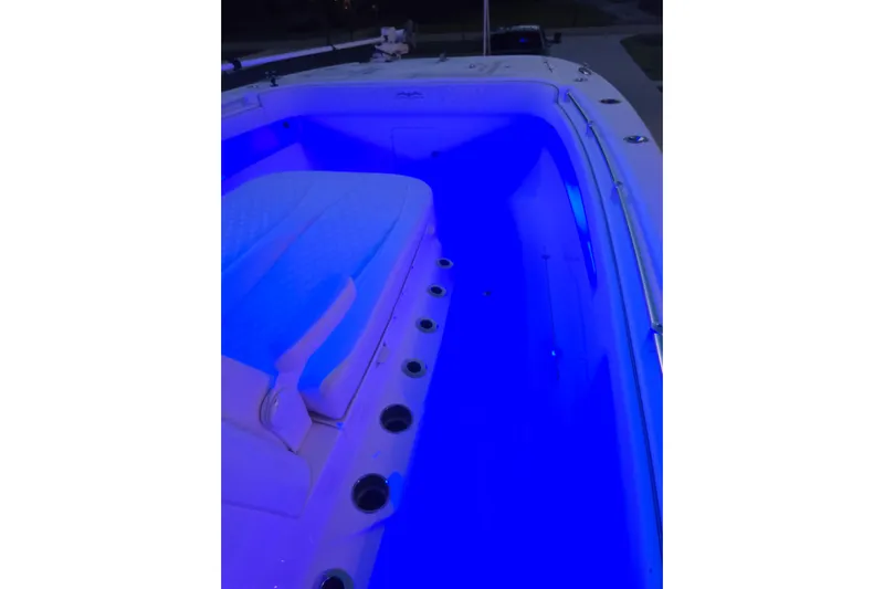 Humble Beginnings Yacht Photos Pics 2022 Invincible 33 Catamaran interior with blue LED lighting and cushioned seating.