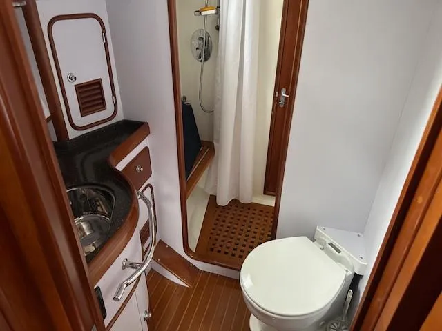 Last Love Yacht Photos Pics Luxurious 2014 Passport 545 Vista yacht bathroom with shower, sink, and toilet.