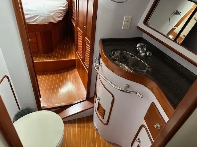 Last Love Yacht Photos Pics Luxurious bathroom in 2014 Passport 545 Vista yacht with wood accents and modern fixtures.