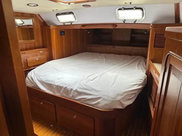 Last Love Yacht Photos Pics Luxurious wooden cabin interior of 2014 Passport 545 Vista yacht with cozy bed.