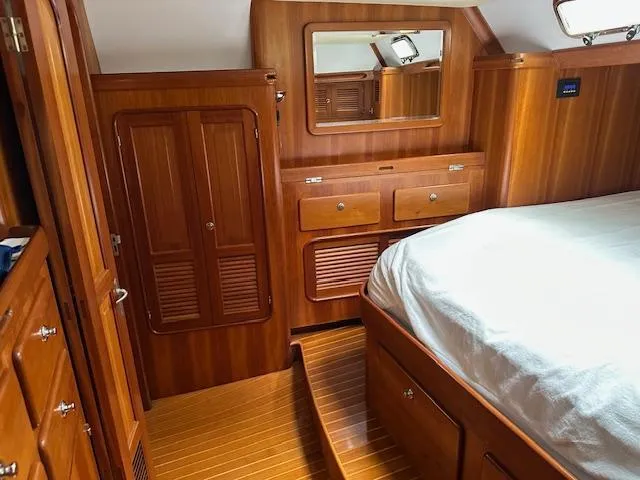 Last Love Yacht Photos Pics Luxurious wooden cabin interior of 2014 Passport 545 Vista yacht with bed and storage.