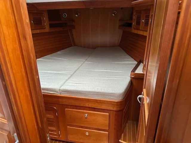 Last Love Yacht Photos Pics Cozy wooden cabin interior of 2014 Passport 545 Vista yacht with comfortable bedding.