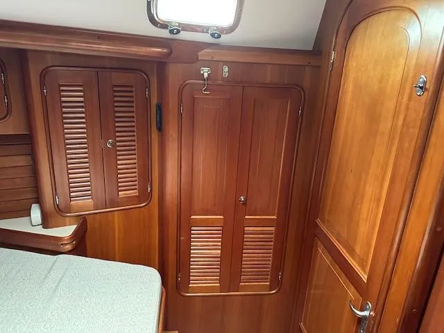 Last Love Yacht Photos Pics Wooden interior of 2014 Passport 545 Vista yacht cabin with storage cabinets.