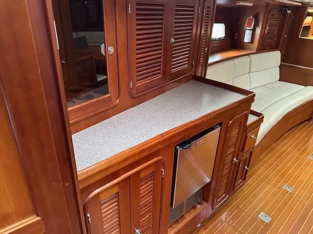Last Love Yacht Photos Pics Luxurious 2014 Passport 545 Vista yacht interior with wooden cabinetry and seating.