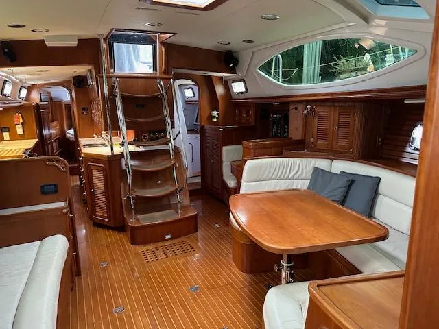 Last Love Yacht Photos Pics Luxurious interior of 2014 Passport 545 Vista yacht with wooden furnishings and seating area.