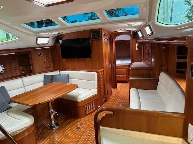 Last Love Yacht Photos Pics Luxurious interior of 2014 Passport 545 Vista yacht with wood finish and seating area.
