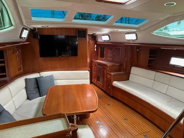 Last Love Yacht Photos Pics Luxurious interior of 2014 Passport 545 Vista yacht with wood finish and seating area.