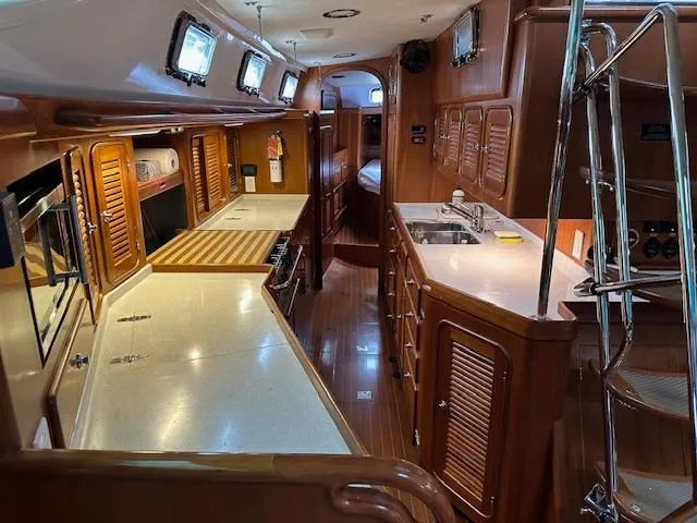Last Love Yacht Photos Pics Luxurious interior of 2014 Passport 545 Vista yacht with modern kitchen amenities.