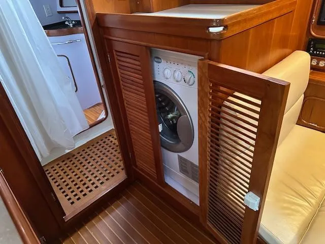 Last Love Yacht Photos Pics Washer in wooden cabinet on 2014 Passport 545 Vista yacht interior.