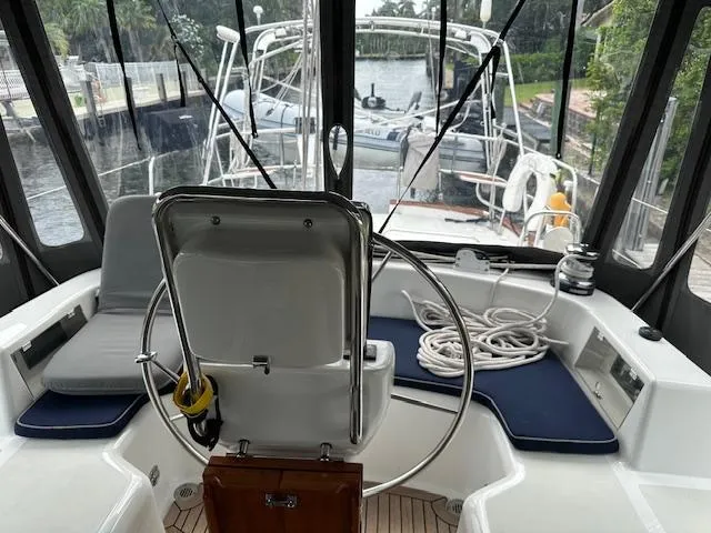 Last Love Yacht Photos Pics 2014 Passport 545 Vista yacht cockpit with steering wheel and seating area.