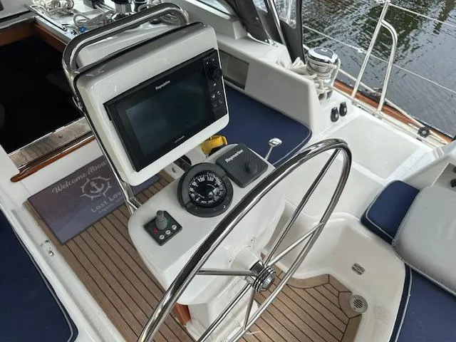 Last Love Yacht Photos Pics Steering wheel and navigation system on 2014 Passport 545 Vista yacht deck.