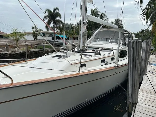 Last Love Yacht Photos Pics Sailboat docked, 2014 Passport 545 Vista, surrounded by tropical scenery.