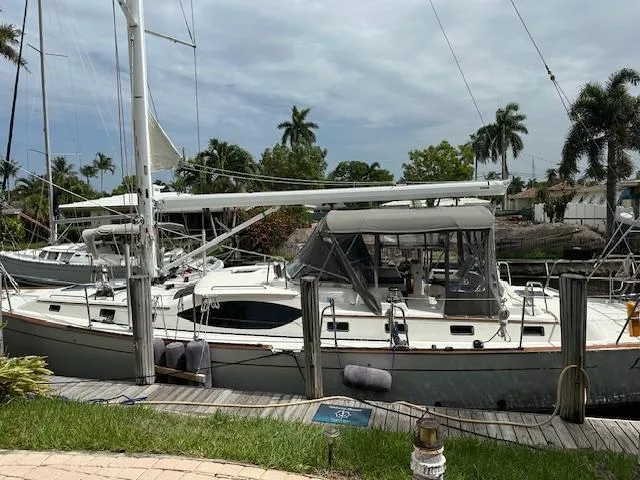 Last Love Yacht Photos Pics Sailboat docked at marina, Passport 545 Vista, 2014 model, surrounded by palm trees.